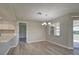 Light and airy dining room with wood-look floors and a chandelier at 3117 Heron Shores Dr, Venice, FL 34293