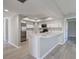 Open concept kitchen with white cabinets, an island, and stainless steel appliances at 3117 Heron Shores Dr, Venice, FL 34293