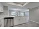 Modern kitchen with stainless steel dishwasher and white shaker cabinets at 3117 Heron Shores Dr, Venice, FL 34293