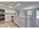 Eat-in kitchen boasts a large island with quartz countertops and stainless steel appliances at 3117 Heron Shores Dr, Venice, FL 34293