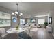 Living room features a staged sitting area and dining table at 3117 Heron Shores Dr, Venice, FL 34293