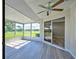 Sunroom with sliding glass doors and wood-look flooring at 3117 Heron Shores Dr, Venice, FL 34293