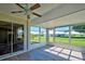 Spacious sunroom with sliding doors and ceiling fan at 3117 Heron Shores Dr, Venice, FL 34293
