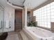 Bathroom with walk-in shower, soaking tub, and glass block window at 315 Park N Blvd, Venice, FL 34285