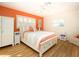 Bedroom with orange accent wall and wood floors at 315 Park N Blvd, Venice, FL 34285