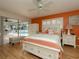 Bedroom with pool view and orange accent wall at 315 Park N Blvd, Venice, FL 34285