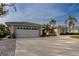Two-car garage and driveway with a nicely landscaped yard at 315 Park N Blvd, Venice, FL 34285