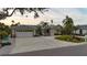 House with a two-car garage and lush landscaping at 315 Park N Blvd, Venice, FL 34285