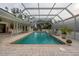 Large screened pool with a spa and brick pavers at 315 Park N Blvd, Venice, FL 34285