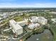 Aerial view of community highlighting building, lake, and surrounding area at 3730 Cadbury Cir # 300, Venice, FL 34293