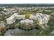 Aerial view of community with multiple buildings, landscaping, and a lake at 3730 Cadbury Cir # 300, Venice, FL 34293