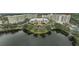 Aerial view of community, showcasing buildings, lake, and lush landscaping at 3730 Cadbury Cir # 300, Venice, FL 34293