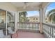 Relaxing balcony with white railings and two wicker chairs, offering a view of tropical landscaping at 3730 Cadbury Cir # 300, Venice, FL 34293