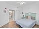 Bedroom with a light teal headboard and access to a private balcony at 3730 Cadbury Cir # 300, Venice, FL 34293