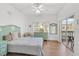 Bedroom with light teal headboard, dresser, and balcony access at 3730 Cadbury Cir # 300, Venice, FL 34293