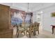 Dining room with glass table, chairs, and a scenic wall mural at 3730 Cadbury Cir # 300, Venice, FL 34293