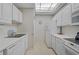 Kitchen with white cabinets, appliances, and floral wallpaper at 3730 Cadbury Cir # 300, Venice, FL 34293