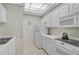 Kitchen with white cabinets, appliances, and floral wallpaper at 3730 Cadbury Cir # 300, Venice, FL 34293