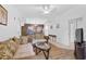 Living room with a sectional sofa, coffee table, and scenic wall mural at 3730 Cadbury Cir # 300, Venice, FL 34293