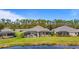 Three homes with screened-in patios overlooking a tranquil lake at 3789 Lakewood Blvd, North Port, FL 34287