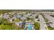 Aerial view of community with lake, pool, and numerous houses at 3789 Lakewood Blvd, North Port, FL 34287