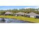 Three houses side by side, showcasing backyard views and lake access at 3789 Lakewood Blvd, North Port, FL 34287
