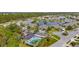 Aerial view of community pool and homes around a lake at 3789 Lakewood Blvd, North Port, FL 34287