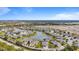 Aerial view of a community with houses, lake, and lush landscaping at 3789 Lakewood Blvd, North Port, FL 34287