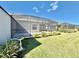 Landscaped backyard with screened patio and bird bath at 3789 Lakewood Blvd, North Port, FL 34287