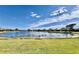 Tranquil backyard oasis with lake view and lush landscaping at 3789 Lakewood Blvd, North Port, FL 34287