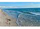 Scenic beach view with calm waves and sandy shoreline at 3789 Lakewood Blvd, North Port, FL 34287