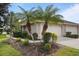 Front exterior view of villa with two palm trees and attached garage at 3789 Lakewood Blvd, North Port, FL 34287