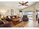 Bright living room features a comfy seating area and lake view at 3789 Lakewood Blvd, North Port, FL 34287