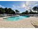 Inviting community pool with surrounding lounge chairs and lush landscaping at 3789 Lakewood Blvd, North Port, FL 34287