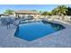 Community pool with lounge chairs and building at 3789 Lakewood Blvd, North Port, FL 34287