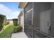 Screened-in porch entry with view of backyard and water at 3789 Lakewood Blvd, North Port, FL 34287