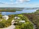 Breathtaking aerial of home, displaying the riverfront location with dock and beautiful landscape at 38 Riverfront Dr, Venice, FL 34293