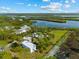 Aerial view of the property showing the main house, storage building, and waterfront at 38 Riverfront Dr, Venice, FL 34293