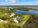 Wide aerial perspective, highlighting the home's expansive waterfront with a private dock at 38 Riverfront Dr, Venice, FL 34293