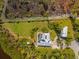 Overhead aerial shot highlights the layout of property's backyard, accessory buildings, and waterfront location at 38 Riverfront Dr, Venice, FL 34293