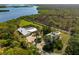Stunning aerial view showcases the property's landscaping, accessory buildings, and natural surroundings at 38 Riverfront Dr, Venice, FL 34293