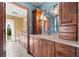 Bathroom showcasing granite countertops, wooden cabinetry, and an open doorway to another section at 38 Riverfront Dr, Venice, FL 34293