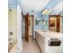 Bright bathroom featuring a large vanity, shower/tub combination and tile flooring at 38 Riverfront Dr, Venice, FL 34293