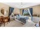 Bright bedroom featuring a ceiling fan, pool view, and a comfortable bed at 38 Riverfront Dr, Venice, FL 34293