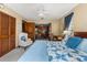 Bedroom featuring closet, desk, chair, and ceiling fan with a glimpse of an adjacent office at 38 Riverfront Dr, Venice, FL 34293