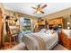 Cozy bedroom with natural light, desk area, built-in shelving and ceiling fan at 38 Riverfront Dr, Venice, FL 34293