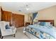 Comfortable bedroom with ample closet space, chair, ceiling fan and natural light at 38 Riverfront Dr, Venice, FL 34293