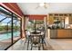 Cozy dining area with pool view featuring a wooden table and hardwood chairs at 38 Riverfront Dr, Venice, FL 34293