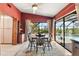 Well-lit dining area with neutral rug, hardwood chairs and pool view at 38 Riverfront Dr, Venice, FL 34293