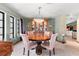 Elegant dining room featuring decorative chandelier, ornate wood table, and built-in china cabinet at 38 Riverfront Dr, Venice, FL 34293